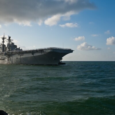 An aircraft carrier, where the Navigators Military Ministry took place, navigating through the ocean.
